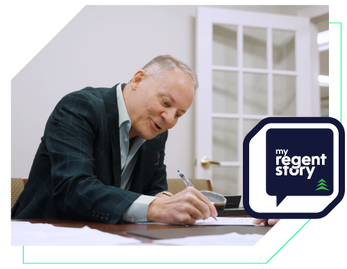 a picture of Doctor Robert Zoellner holding a pen signing a document