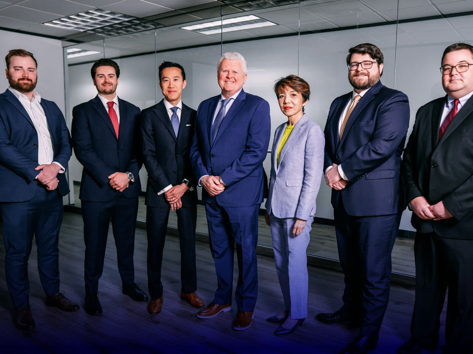 Regent Bank Dallas lending office leadership team standing together in a modern office setting.